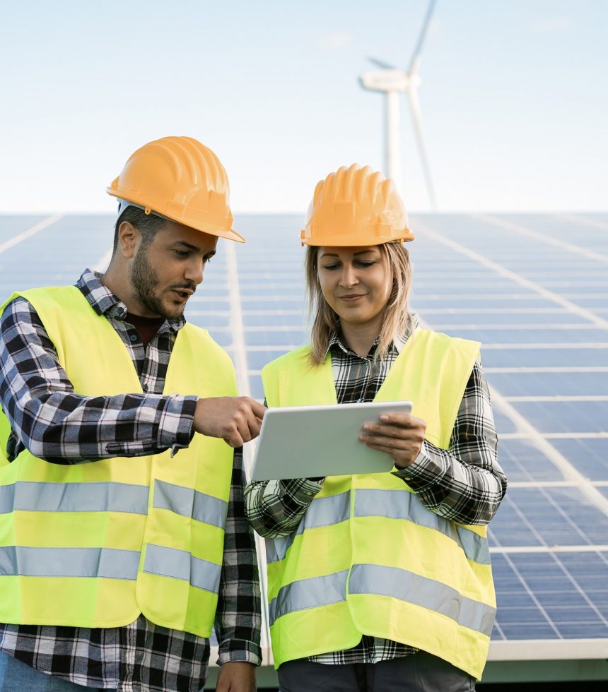 young-people-working-with-digital-tablet-at-renewable-energy-farm-focus-on-faces.jpg